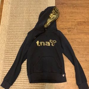 TNA sweater in black and gold